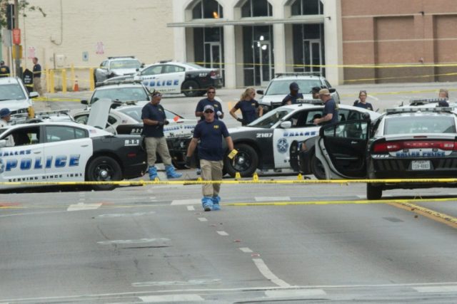 FBI agents examine the crime scene of the Dallas, Texas, sniper shooting on July 9, 2016
