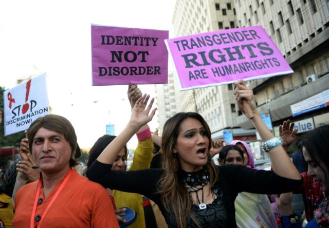 Pakistani transgenders carry signs at a rally in Karachi on November 30, 2013