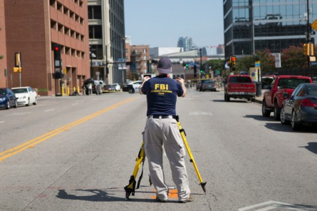 FBI and police investigate on July 8, 2016 the site of the shooting that left five police