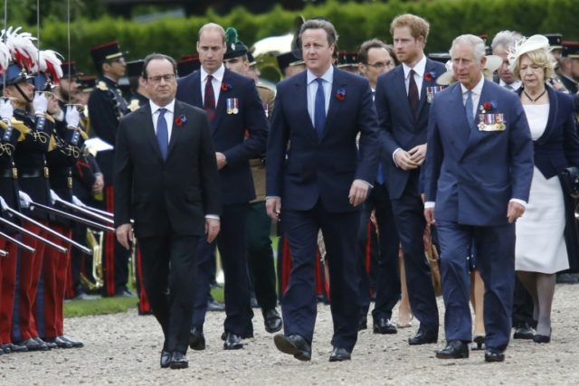 French President Francois Hollande (left) walks alongside British Prime Minister David Cam