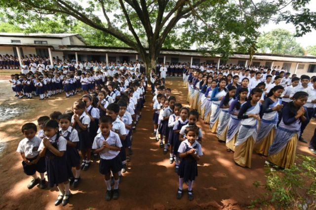 Schoolchildren take part in morning prayers at the Rashtriya Swayamsevak Sangh-run Sankard
