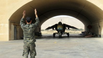 A Syrian army jet is guided out of the hangar at Dmeir military airport, 50 km north-east of Damascus, on April 8, 2016