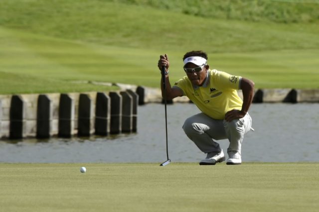 Thai golfer Thongchai Jaidee lines up a putt on the 18th green during the 3rd round of the