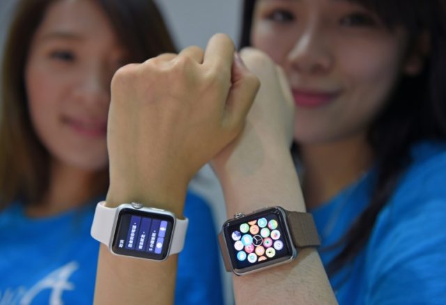 Staff at an Apple store display the company's new Apple Watch as it goes on sale in Taipei