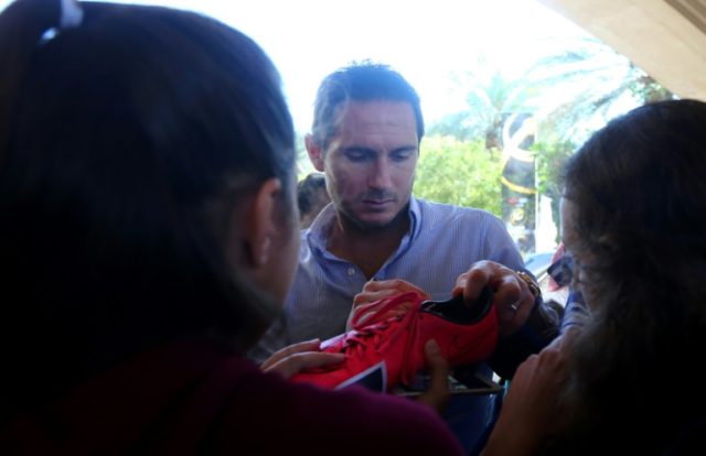 Frank Lampard (C) of New York City FC signs his autograph for a fan in Dubai, in December