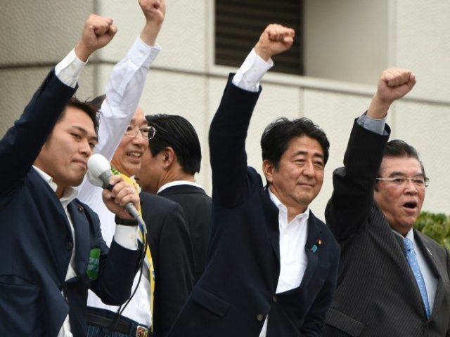 Japanese Prime Minister Shinzo Abe (2nd R) campaigns in Tokyo on July 9, 2016, on the eve