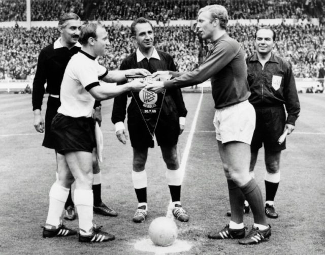 West Germany captain Uwe Seeler (left) and England's Bobby Moore exchange pennants before