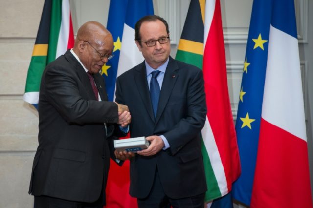 French President Francois Hollande (right) gives an audio recording of Nelson Mandela to S
