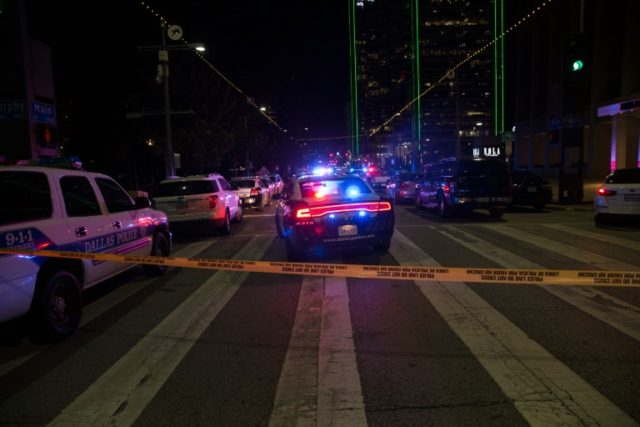 Police cars sit on Main Street in Dallas following the sniper shooting during a protest on