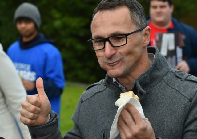 Leader of the Australian Greens Party Richard Di Natale enjoys a sausage from a primary sc