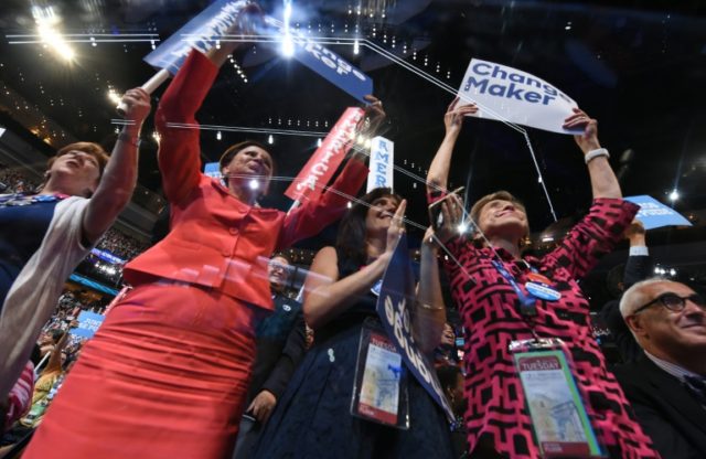 Delegates cheer as former president Bill Clinton speaks on day two of the Democratic Natio