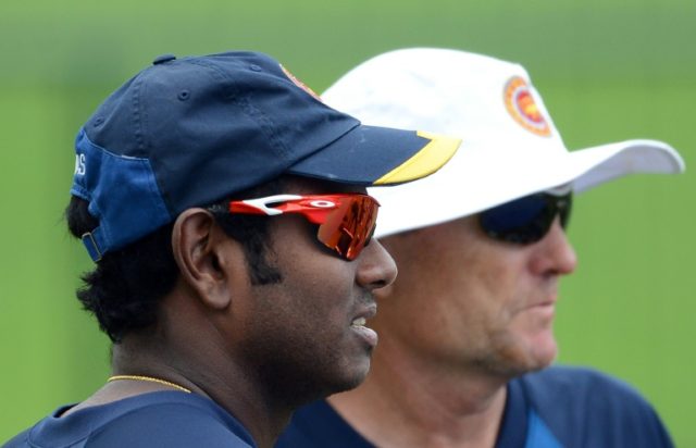 Sri Lanka's captain Angelo Mathews (L) and coach Graham Ford watch other players during a