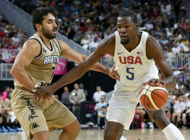 Kevin Durant (R) of the US drives past Facundo Campazzo of Argentina during a USA Basketba