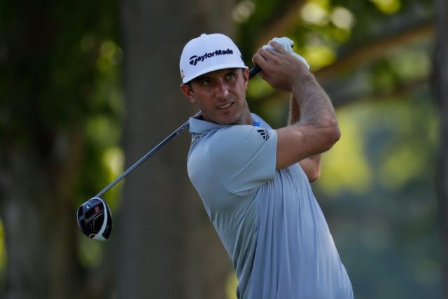 Dustin Johnson of the United States reacts to his tee shot during a practice round prior t