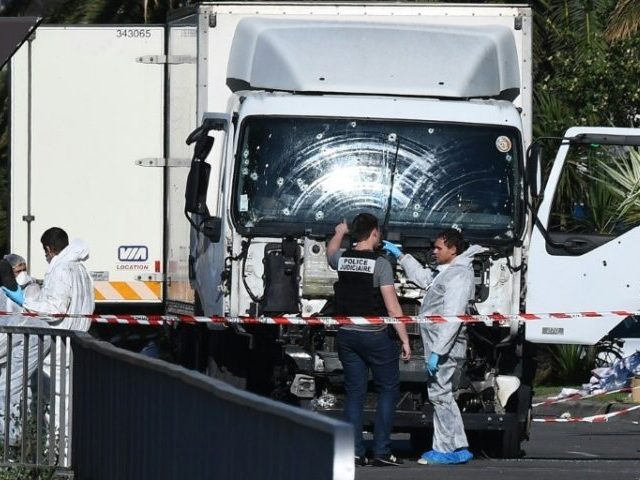 French forensic officers look for evidence near a truck which ploughed through a crowd celebrating Bastille Day in Nice, on July 15, 2016