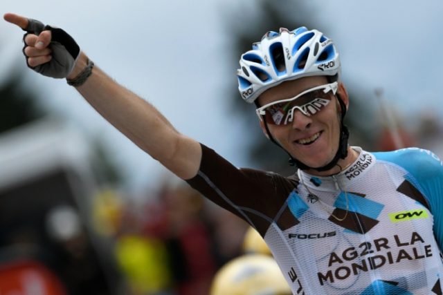 France's Romain Bardet celebrates as he crosses the finish line at the end of the 19th sta