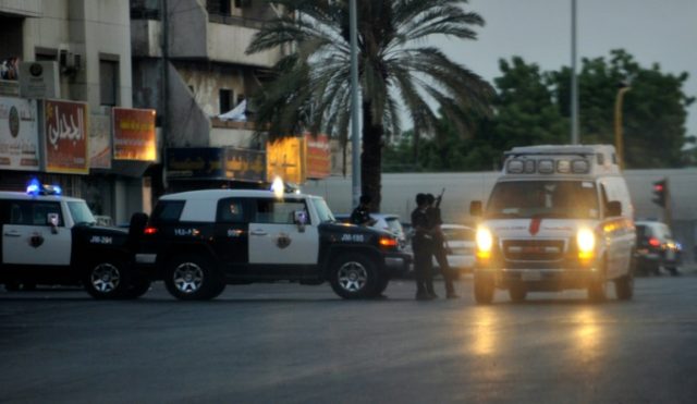 Saudi policemen stand guard at the site where a suicide bomber blew himself up in the earl