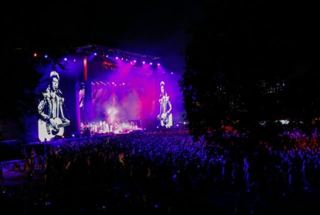 An image of David Bowie is seen at the stage as Arcade Fire performs during Panorama music