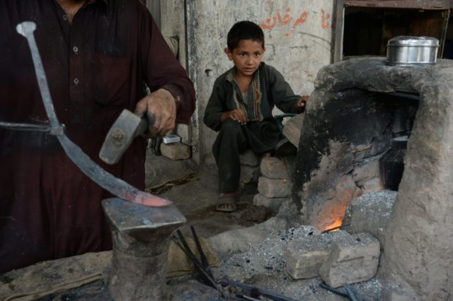 An Afghan child labourer works at a blacksmiths shop on the outskirts of Jalalabad