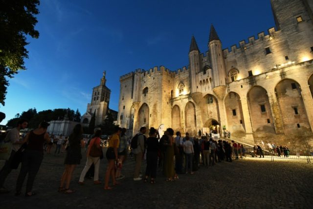 Spectators queue to enter the Palais des Papes to attend the play of Ivo Van Hove "The Dam