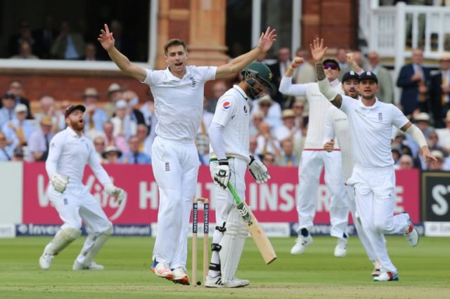 England bowler Chris Woakes (2nd left) celebrates as Pakistan's Shan Masood is caught behi