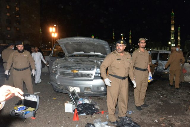 Saudi security personnel gather at the site of the suicide attack near the Prophet's Mosqu