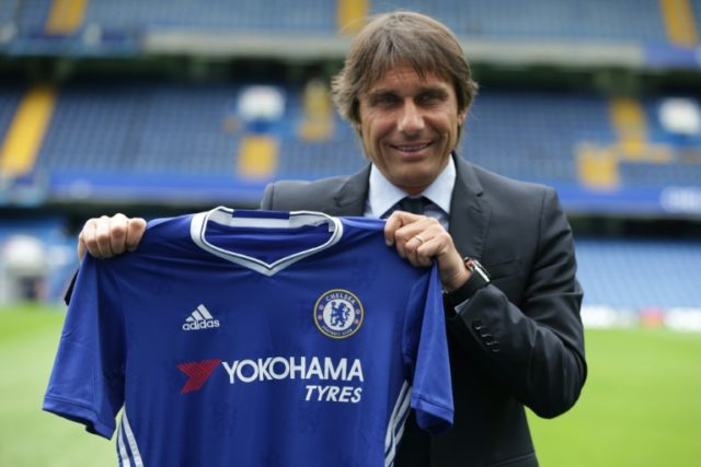 Chelsea's newly appointed Italian manager Antonio Conte poses for photographs on the pitch