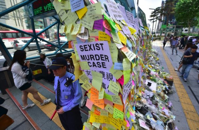 An exit of Seoul's Gangnam station is turned into a shrine for a 23-year-old woman who was