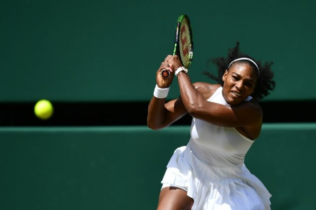 Serena Williams of the US returns to Russia's Elena Vesnina during their Wimbledon Champio