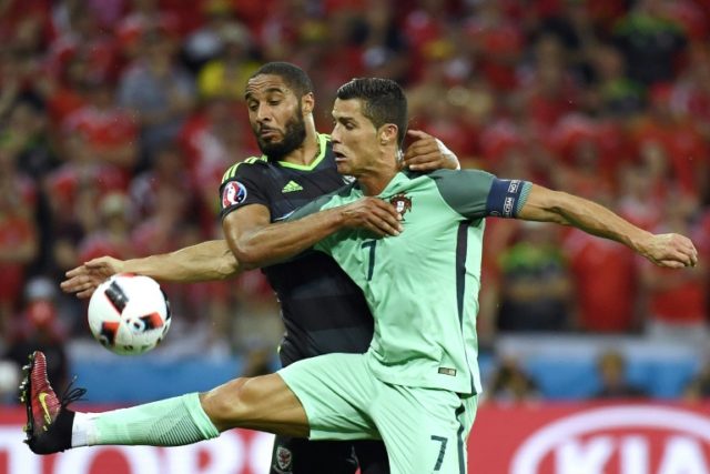 Wales' Ashley Williams (L) fights for the ball with Portugal's Cristiano Ronaldo during th