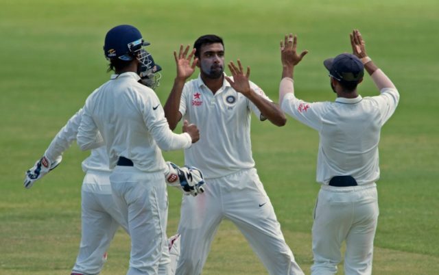 India's cricketer Ravichandran Ashwin (C) celebrates during day four of the test match aga