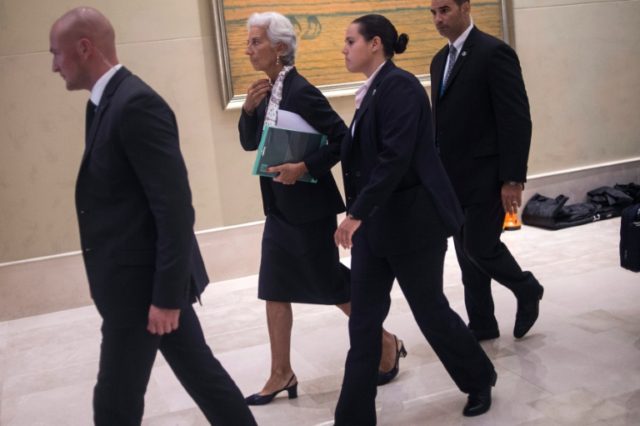 International Monetary Fund (IMF) Managing-Director Christine Lagarde (C) arrives to take
