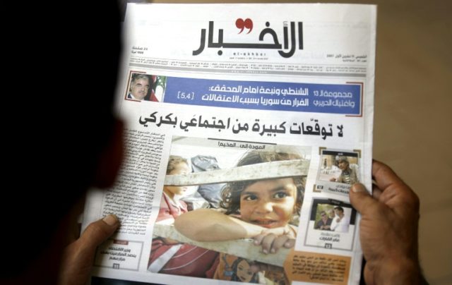 This photo taken on October 11, 2007 shows a Lebanese man reading a copy of al-Akhbar news