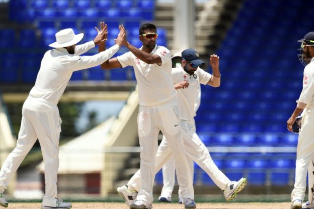 Indian cricketer Ravichandran Ashwin (C) celebrates dismissing WICB President's XI batman