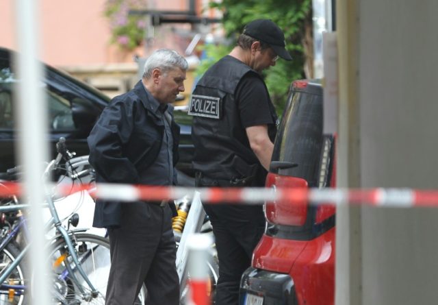 Police work at a site where a Syrian migrant set off an explosive device in Ansbach, south