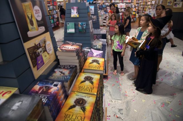 Children watch a video preview at a book store during the launch of the new "Harry Potter