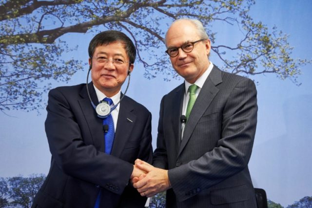Chairman of Swiss farm chemicals giant Syngenta, Michel Demare (R), shakes hands with Chai