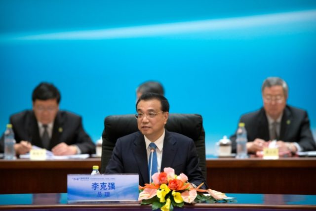China's Premier Li Keqiang (C) speaks at the 1+6 meeting on promoting growth in the Chines