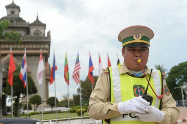 A policeman directs traffic in Vientiane on July 23, 2016, as Laos hosts the 49th South E