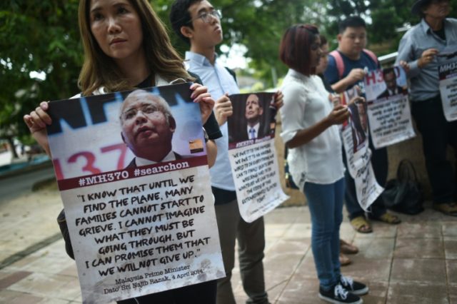 Relatives of passengers, missing from Malaysia Airlines flight MH370, demonstrate at the M