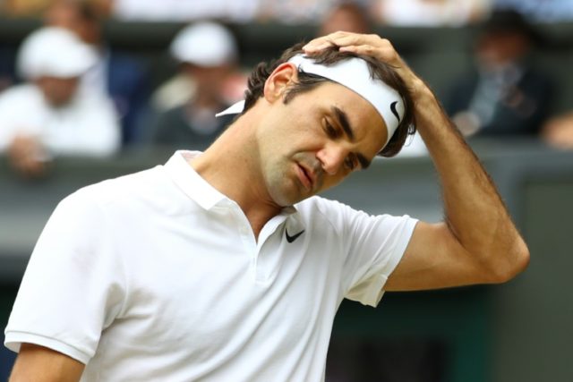 Switzerland's Roger Federer reacts after losing a point to Canada's Milos Raonic during th
