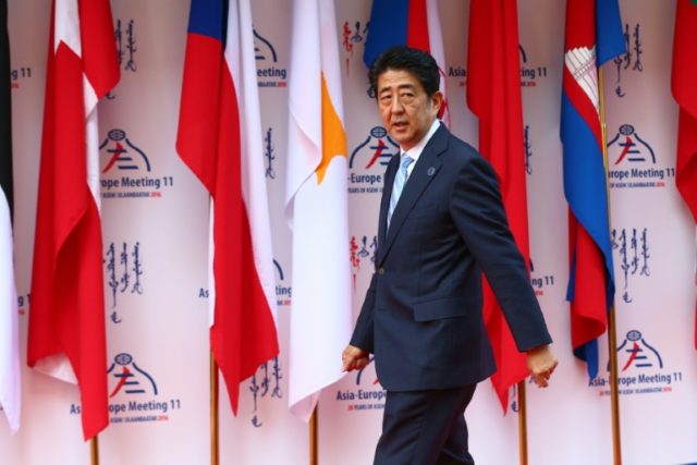 Japanese Prime Minister Shinzo Abe arrives for the 11th Asia-Europe Meeting (ASEM) Summit