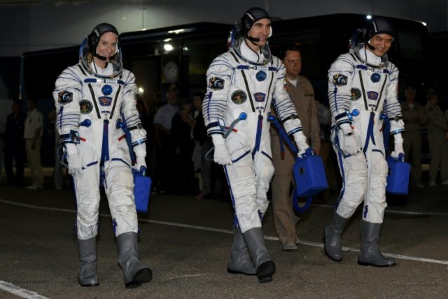 First-time astronauts Kathleen Rubins of NASA (L) and Takuya Onishi of the Japanese space