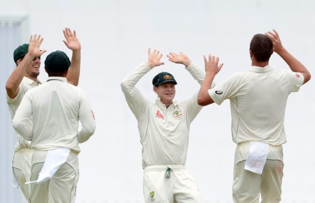 Australia's Josh Hazlewood (R) celebrates with teammates after dismissing Sri Lanka's Dine