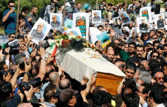 The coffin of Iranian film-maker Abbas Kiarostami, who died aged 76, makes its way through
