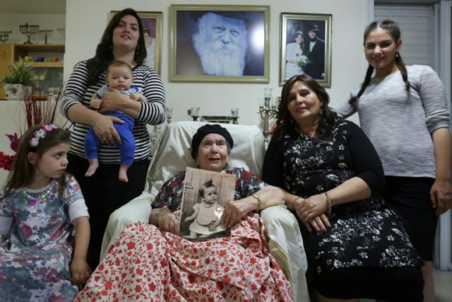 Frecha Amar, 84, of Moroccan descent, holds a picture of her baby, who she says was abduct