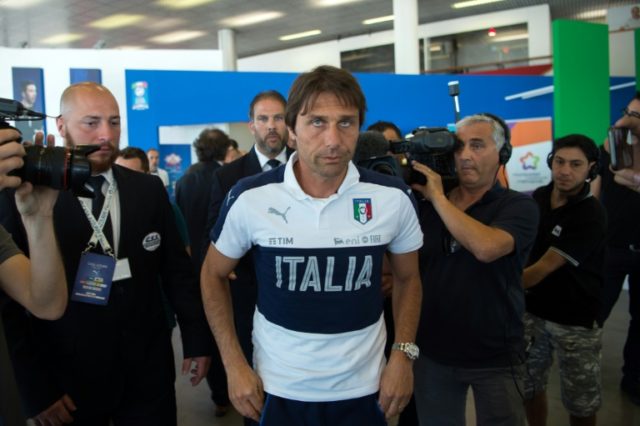 Italy's coach Antonio Conte (C) leaves a press conference following the defeat against Ger