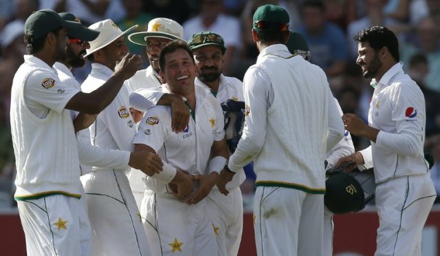 Pakistan's Yasir Shah (C) is congratulated after taking the wicket of England's Jonny Bair