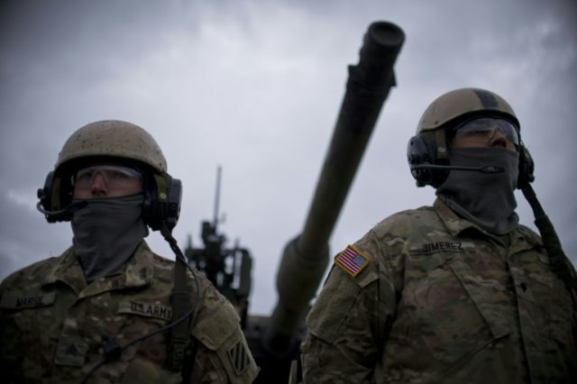 US soldiers stand in front of US M1 Abrams tank during a NATO military exercise in Bulgari
