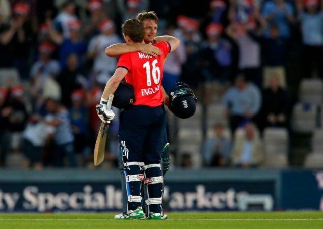 England's captain Eoin Morgan (L) and Jos Buttler embrace after England win the game by 8